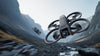 Two DJI Avata 2 drones flying with a mountainous background