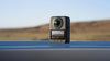 DJI Osmo 360 camera stood on water surface with mountainous background