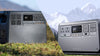 Two DJI portable power stations stood on grass in a natural setting