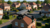 Grey drone flying over private residential homes