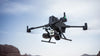 DJI Matrice 400 enterprise drone flying with multiple attachments on it