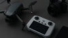 Grey drone and remote controller on a table