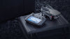 Drone and remote controller on a hard case with rock ground in the background