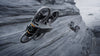 Two DJI Avata 2 grey drones against a mountainous background with a lake