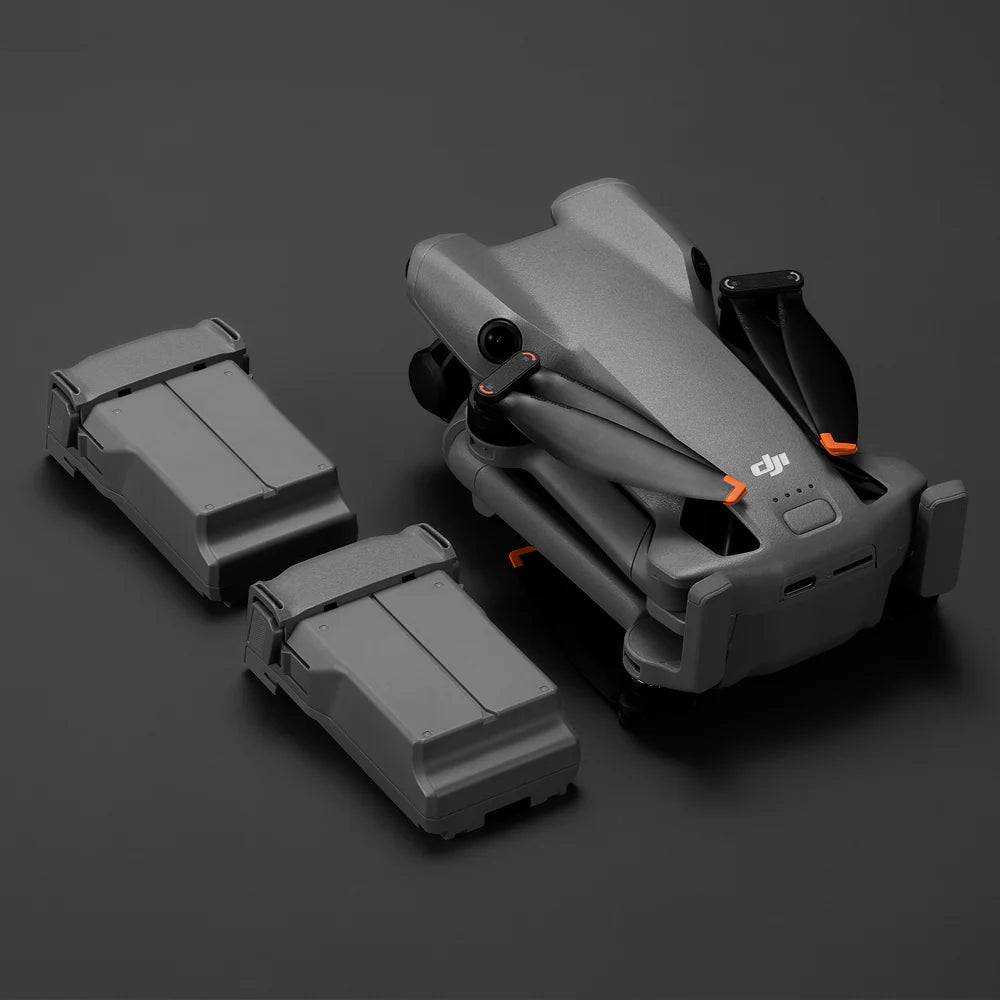 Grey Mini 5 Pro drone with two batteries on a dark background