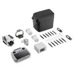 Mini 4 Pro drone with RC 2 remote controller, multiple batteries, propellers and cables on a white background