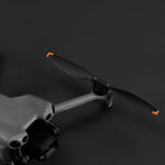 Grey drone with a black propeller on a dark background