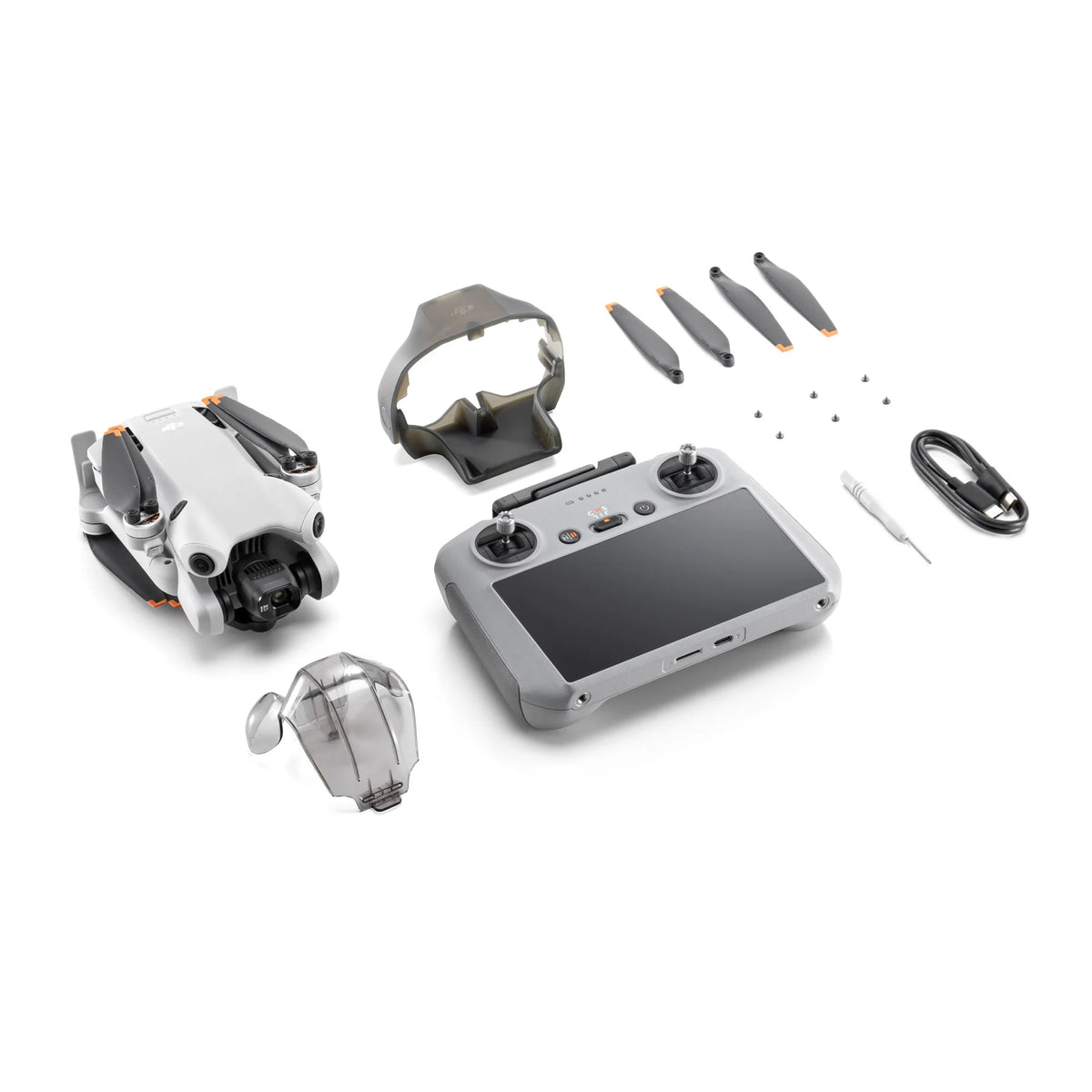 DJI Mini 4 Pro drone with RC 2 remote control, propellers, gimbal protector and cable on a white background
