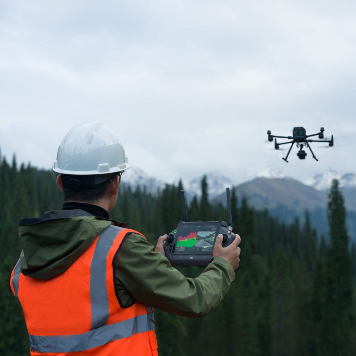 Man operating remote controller with Matrice enterprise drone flying in the background with a natural setting