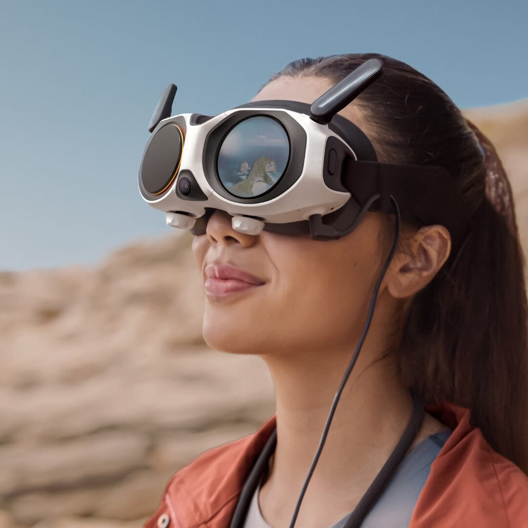 Person wearing FPV vision goggles in a desert setting