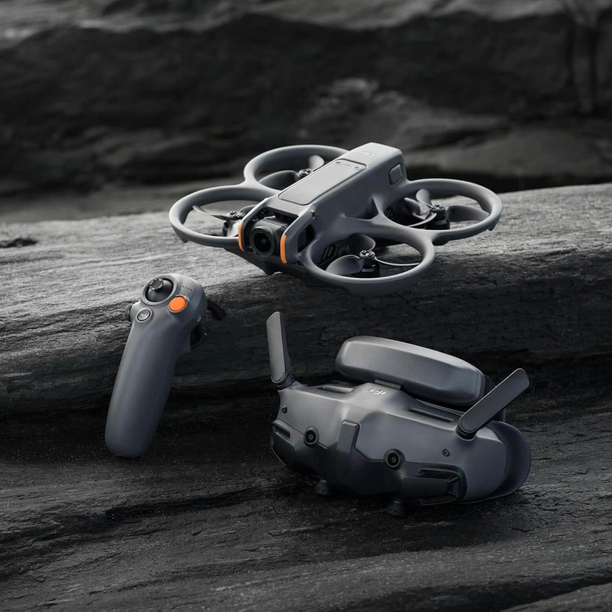 DJI Avata 2 drone, FPV goggles and remote control on a wooden surface with a dark background