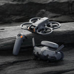 DJI Avata 2 drone, FPV goggles and remote control on a wooden surface with a dark background