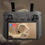 DJI RC Pro.2 Enterprise drone remote controller with screen displaying a live feed of a ring on sand