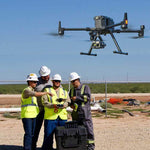Three men surrounding someone operating a large enterprise drone in a construction setting