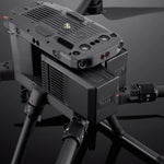 Close-up of a large enterprise drone with TB65 battery being inserted on a dark background