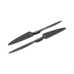 Two black drone propellers on a white background