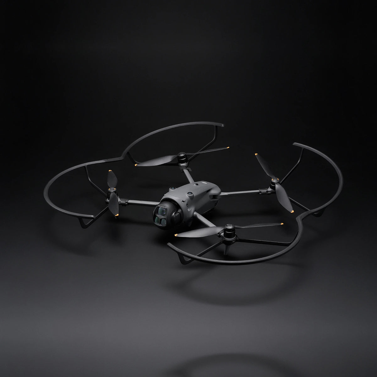 Mavic 4 Pro drone with attached propeller guards on a dark background