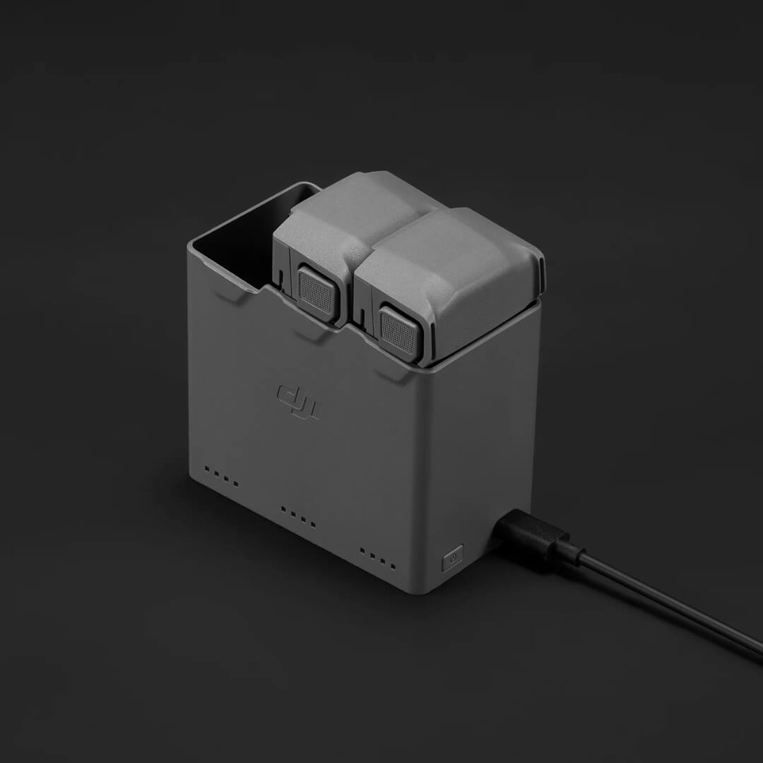 DJI battery charging hub with a cable on a black background