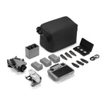 Drone, 3 batteries, remote controller, storage bag and accessories on a white background from front right angle