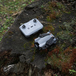 DJI Mini 5 Pro drone and RC-N3 controller on a mossy tree stump