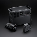 Grey portable Power 2000 station with a drone and battery charging hub on a dark background