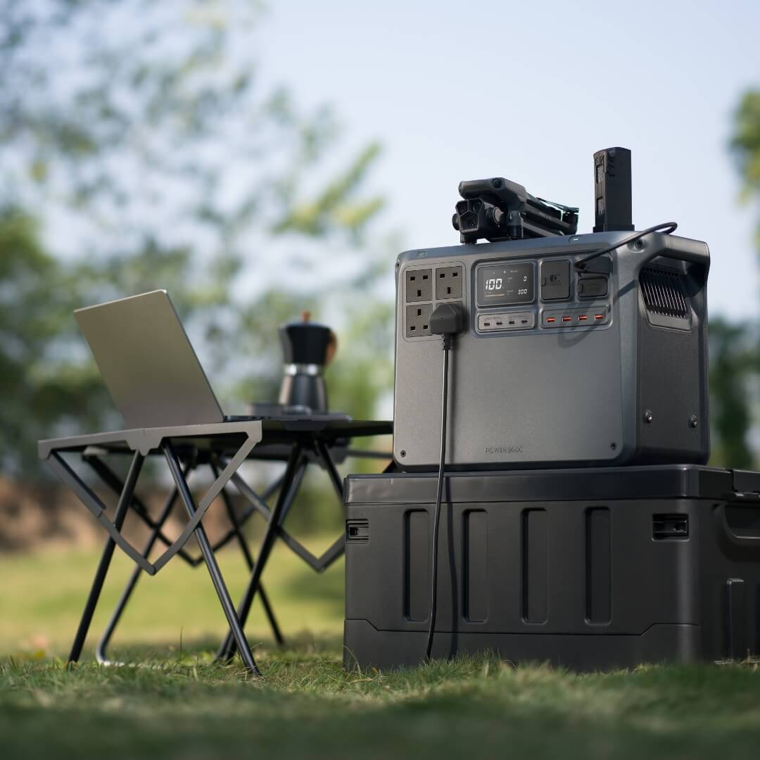 Portable power station with laptop and chair in outdoor setting