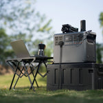 Portable power station with laptop and chair in outdoor setting
