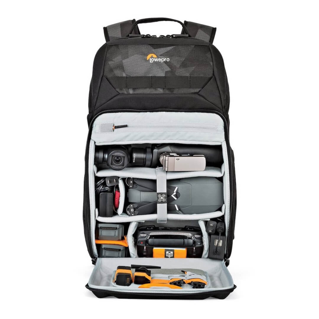 Camera backpack with compartments filled with photography equipment on a white background