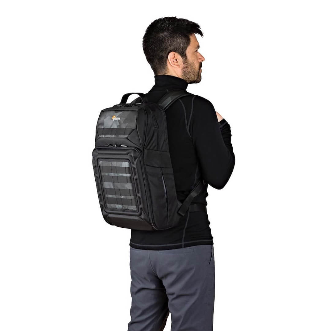 Man wearing a black backpack on a white background