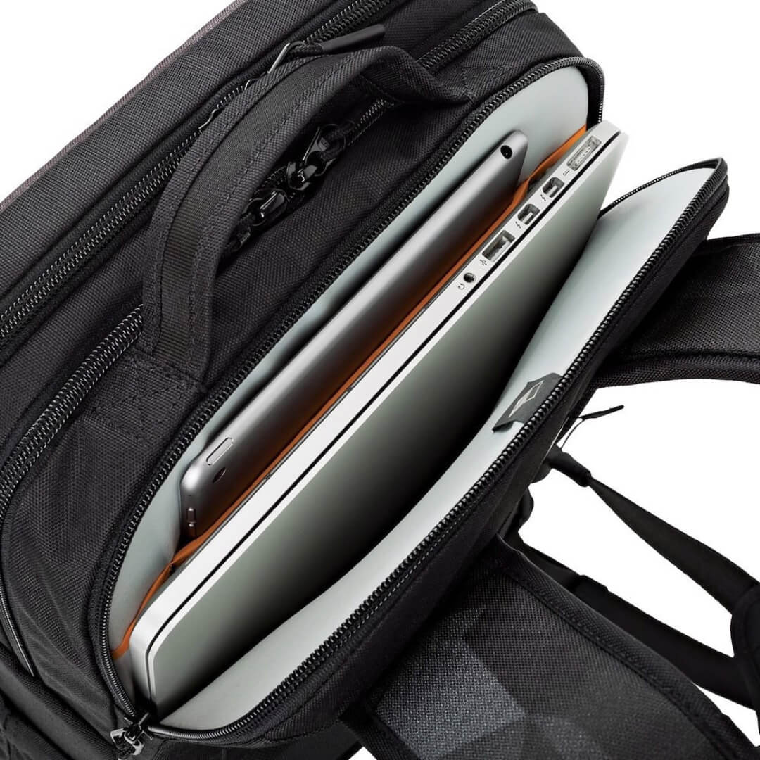 Black backpack with an open compartment containing a silver laptop and tablet