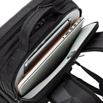 Black backpack with an open compartment containing a silver laptop and tablet
