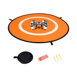 Drone landing pad with drone, carrying case, and accessories on a white background