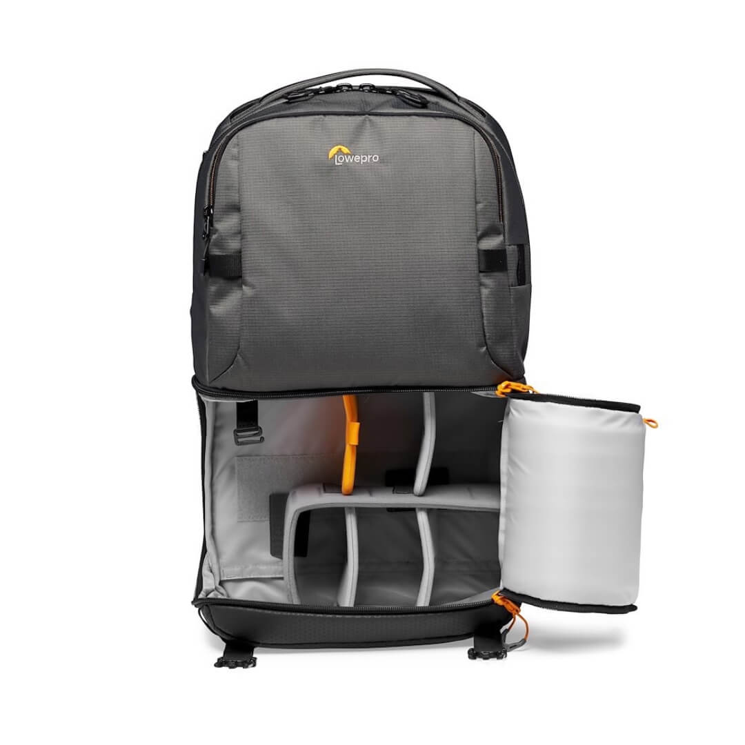 Grey backpack with open camera compartment on a white background