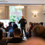 Trainer giving a presentation to students in a well-lit room