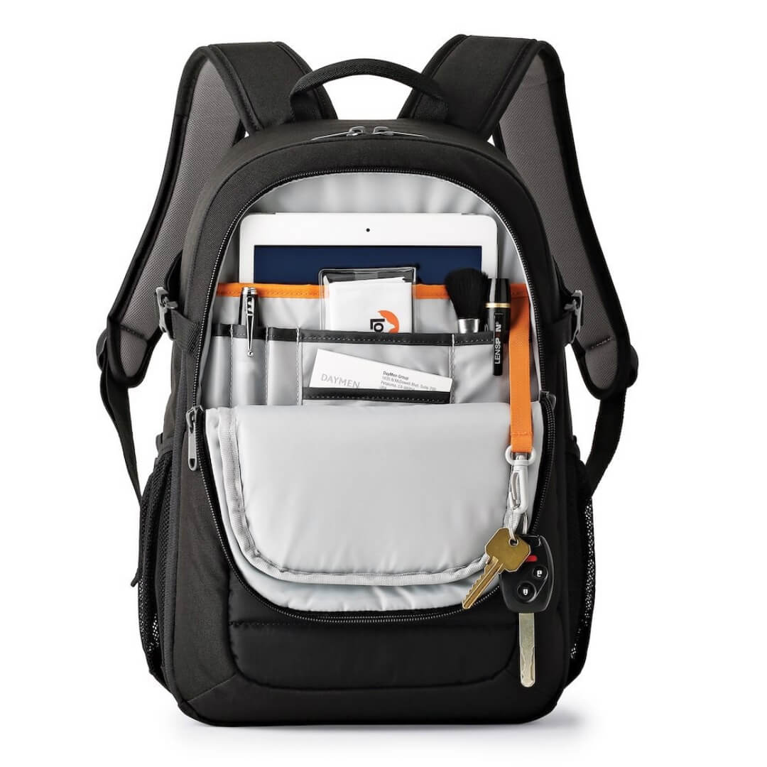 Black backpack with tablet and stationary on a white background