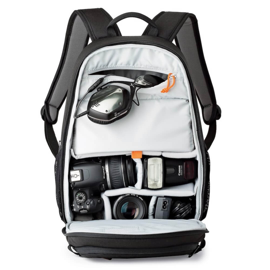 Black backpack with camera equipment on a white background