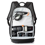 Black backpack with camera equipment on a white background