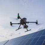 Drone flying over a solar panel with a clear sky background