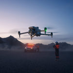 DJ Matrice 4T drone flying over a desert landscape with mountains in the background