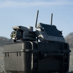 DJI Matrice 4T drone and remote control on a black hard case with a mountainous background