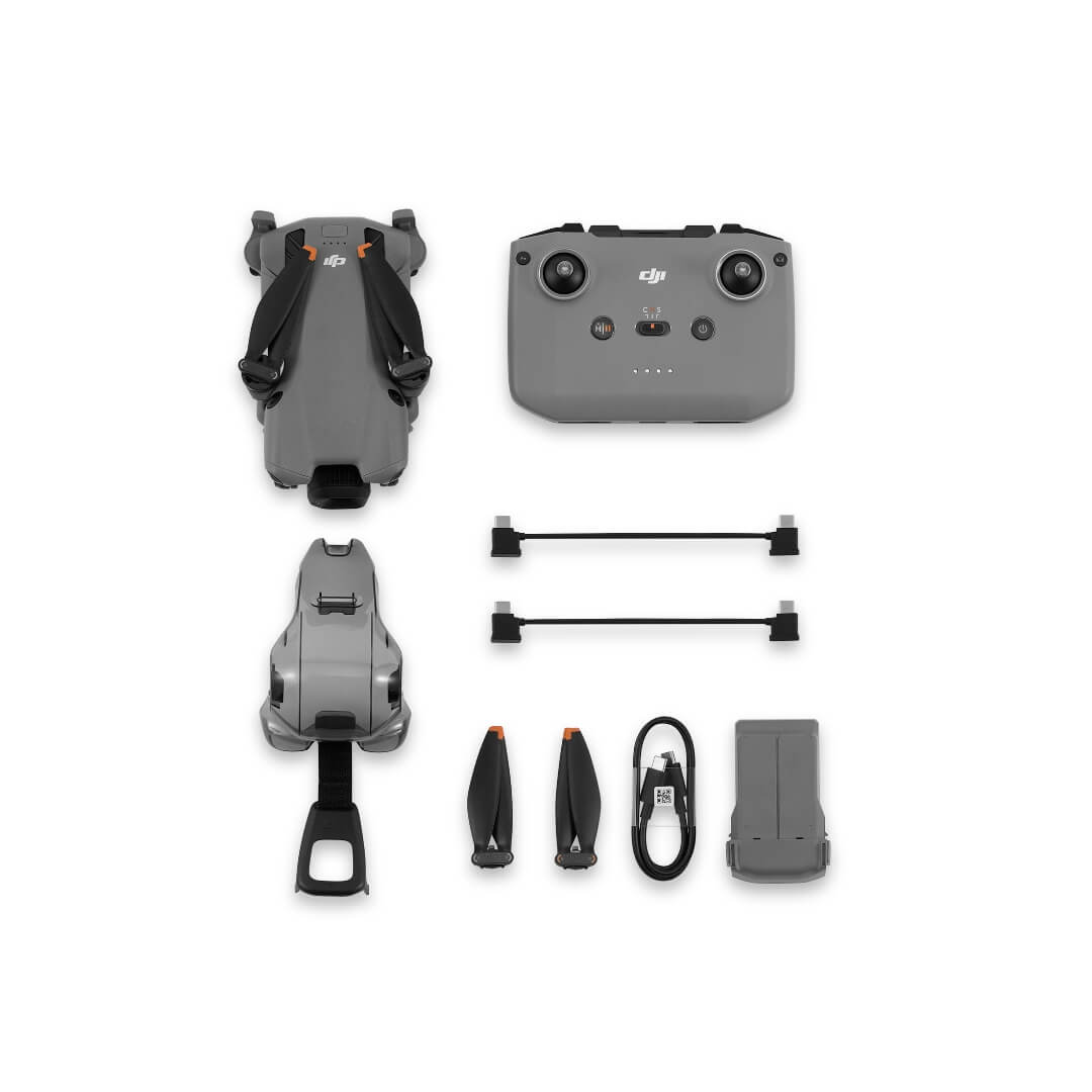 Mini 5 Pro drone with battery, propellors, controller and cables from birds-eye view on a white background