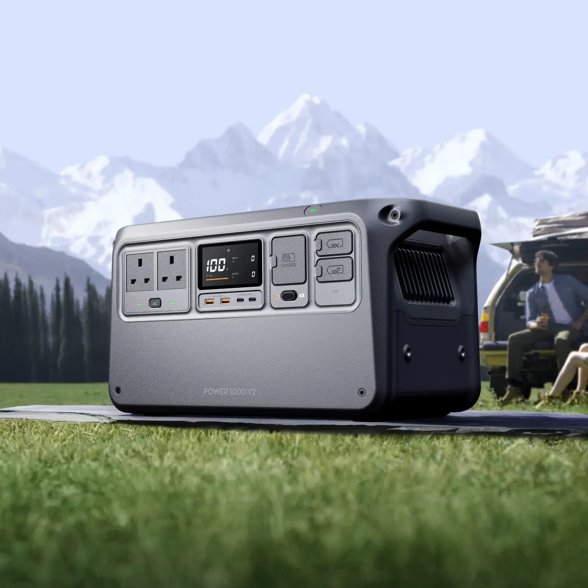 Portable Power 1000 V2 station on grass with mountains in the background