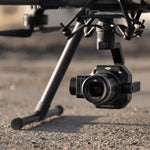 Close-up of a P1 camera sensor payload with DJI branding on a blurred background