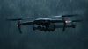 Grey drone flying in the rain at night