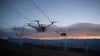 Two DJI Matrice enterprise drones flying with mountainous sunset background