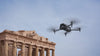 DJI Matrice grey drone flying with ruins in the background