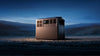 A power station on a stony surface with a night sky in the background
