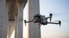 Matrice drone flying under a bridge with sunrise background