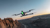 antigravity a1 grey drone flying in the sky with a mountainous background