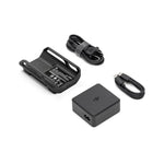 Set of electronic accessories including a power adapter, cables and a small black charging hub with a DJI logo on a white background